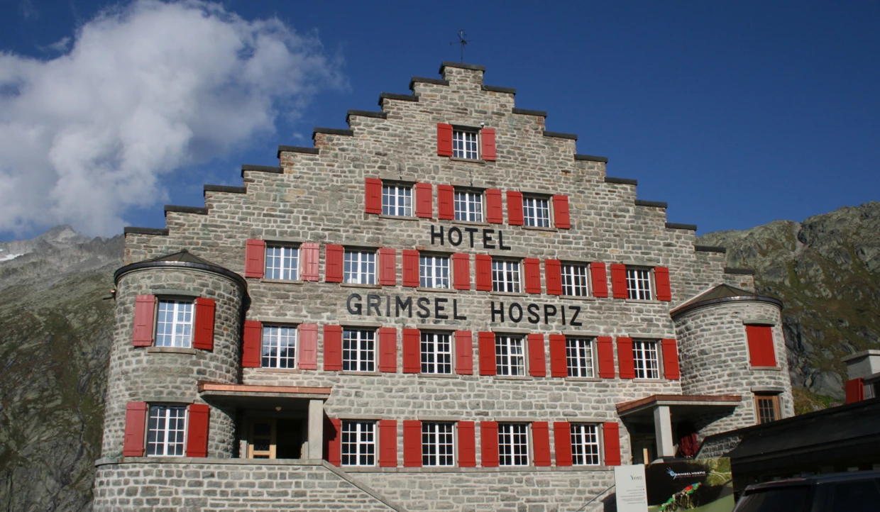 Stone building with red shutters and Grimsel Hospiz sign