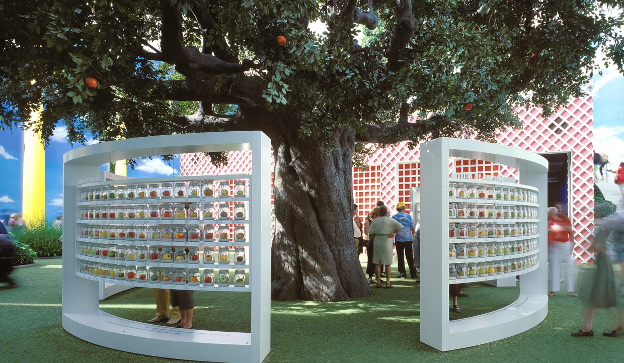 Dekorierter Baum mit Gläsern und Menschen in einem Ausstellungsraum