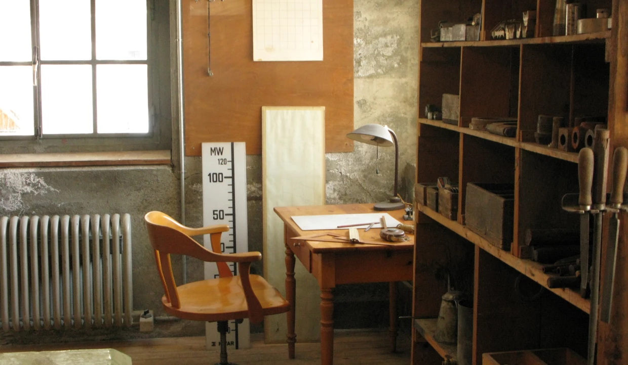 Wooden chair and desk with lamp in workshop