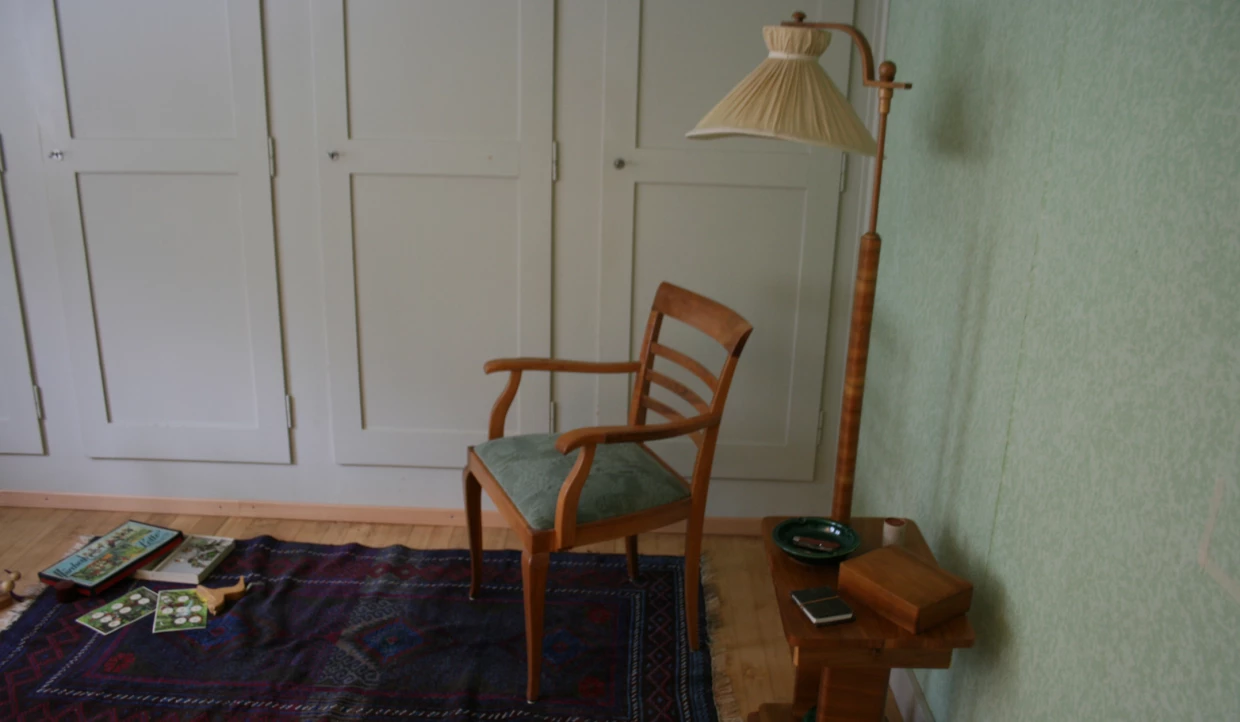 Chair on carpet with floor lamp and side table