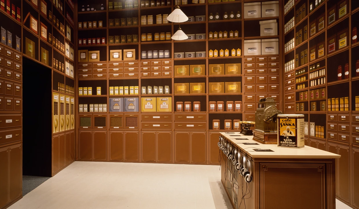 Showcase with coffee cans and cash register in exhibition room