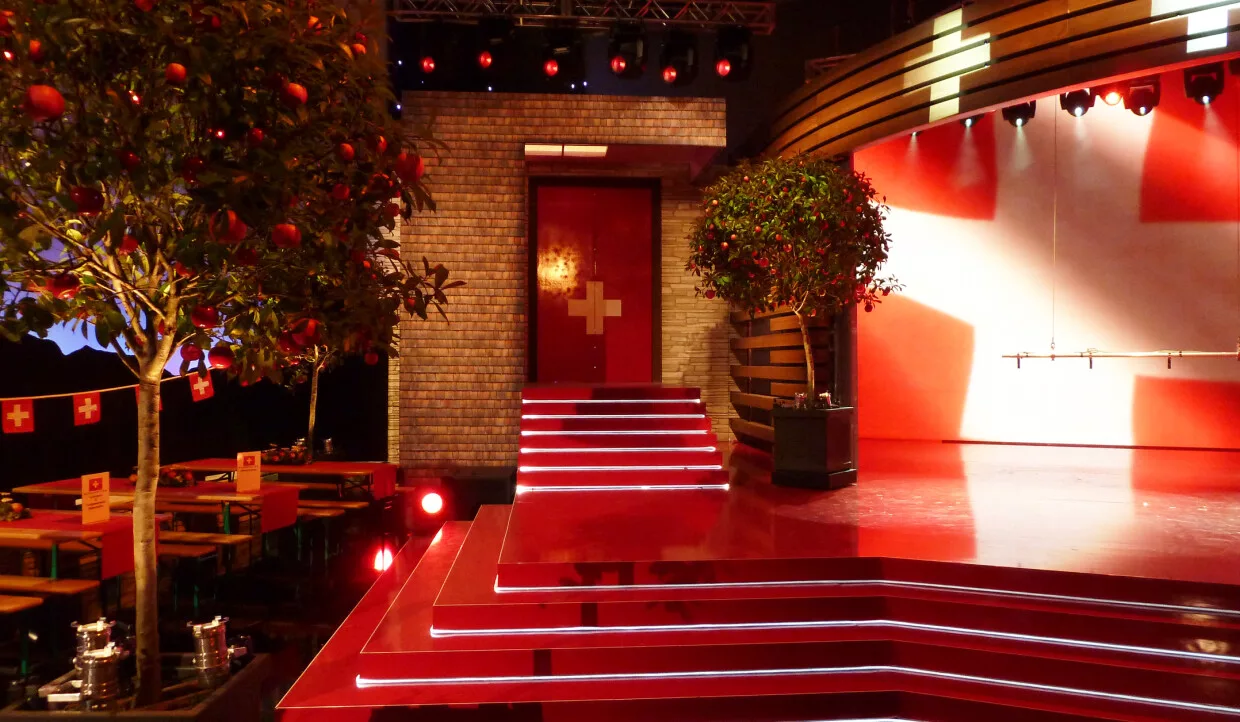 Stage with stairs, red carpet, and trees