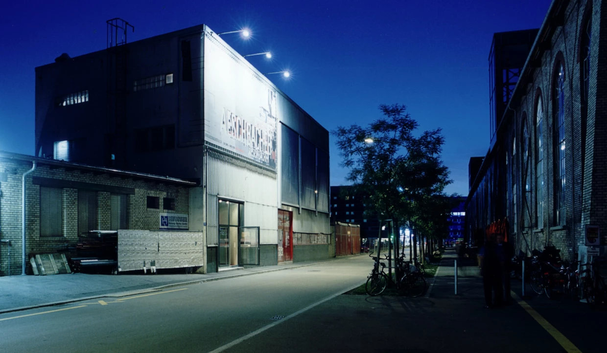 Industrial building at night with illuminated billboard