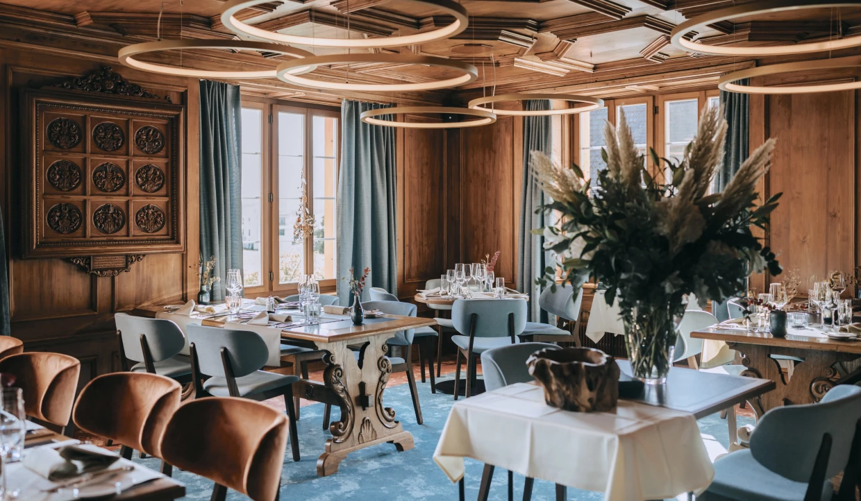 Cozy dining room with wooden furniture and large windows
