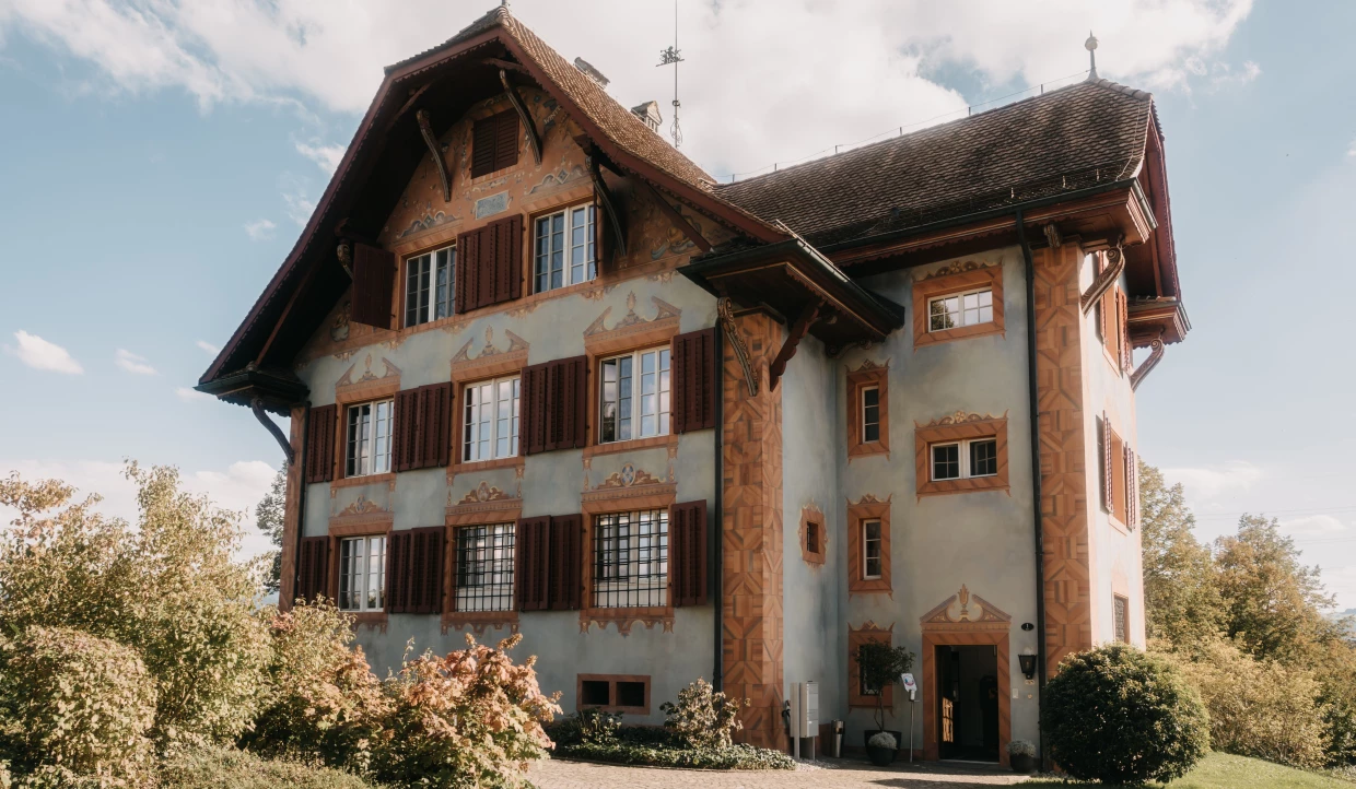 Historic country restaurant with wooden shutters and facade painting