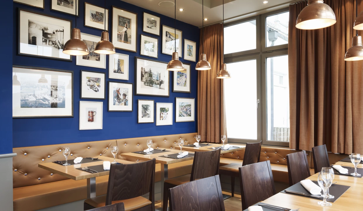 Dining area with brown bench, blue picture wall.