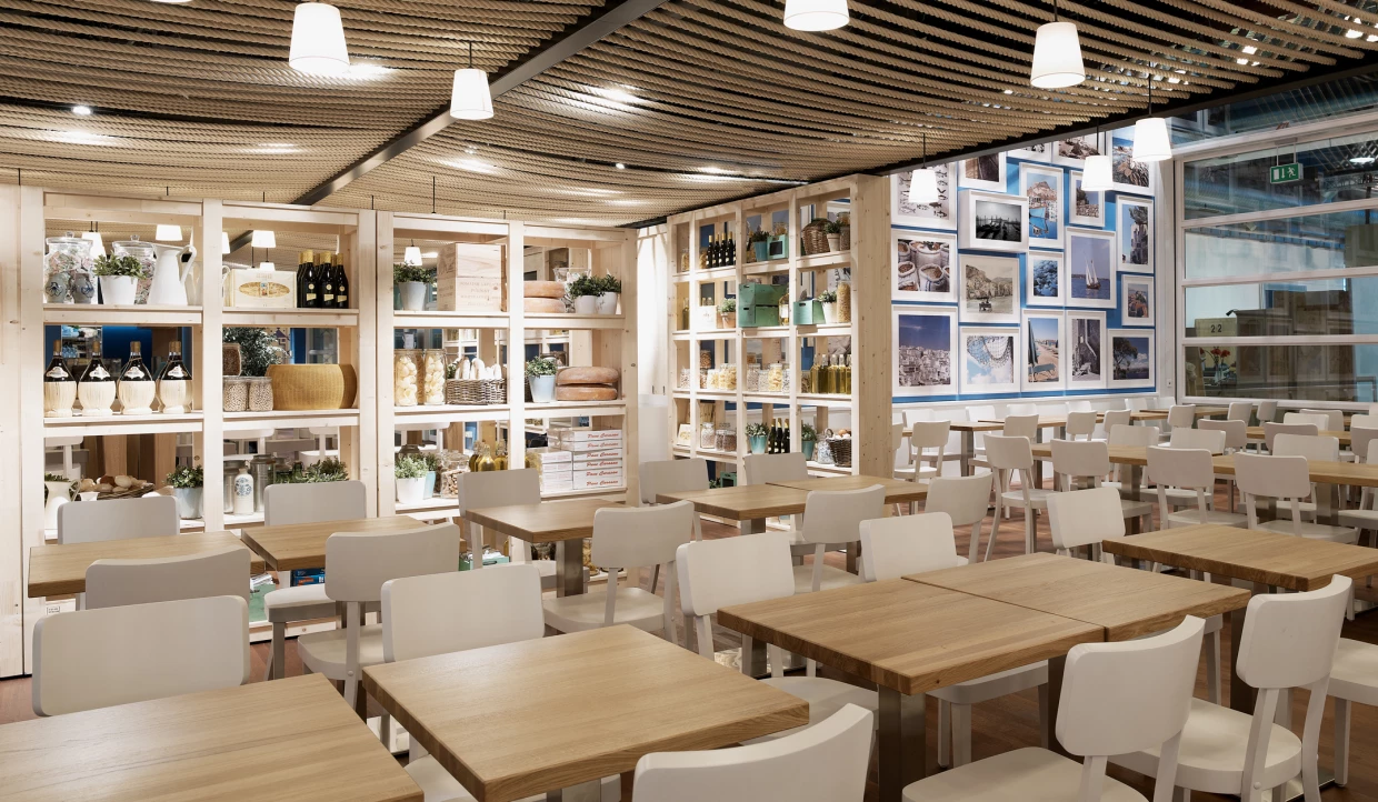 Dining area with wall shelves, white chairs, and table decorations.