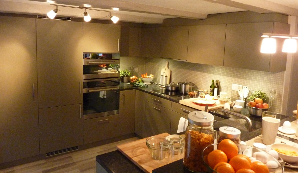Modern kitchen with grey cabinets and fruit on the counter