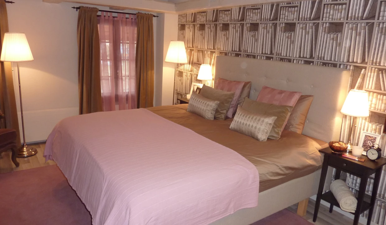 Bedroom with double bed and bookshelf wallpaper