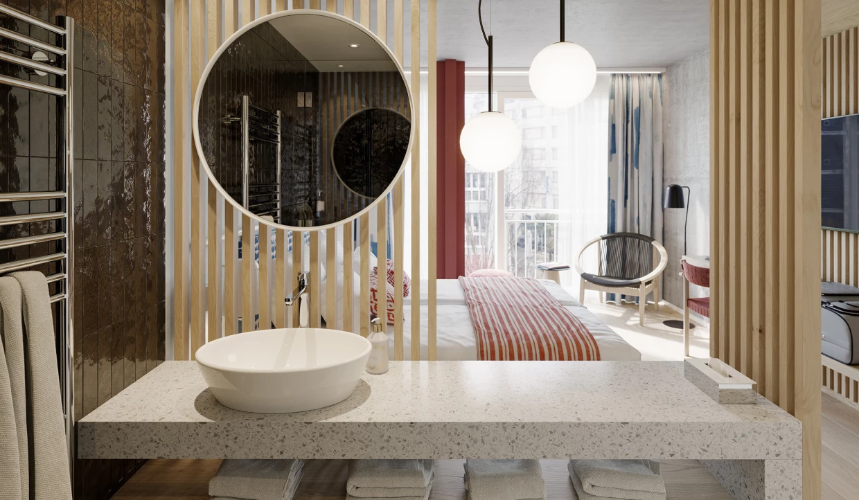 Badezimmer mit Waschtisch, rundem Spiegel und Blick ins Schlafzimmer
