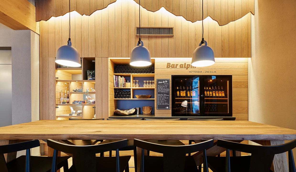 Barbereich mit Holzwänden und hängenden Lampen