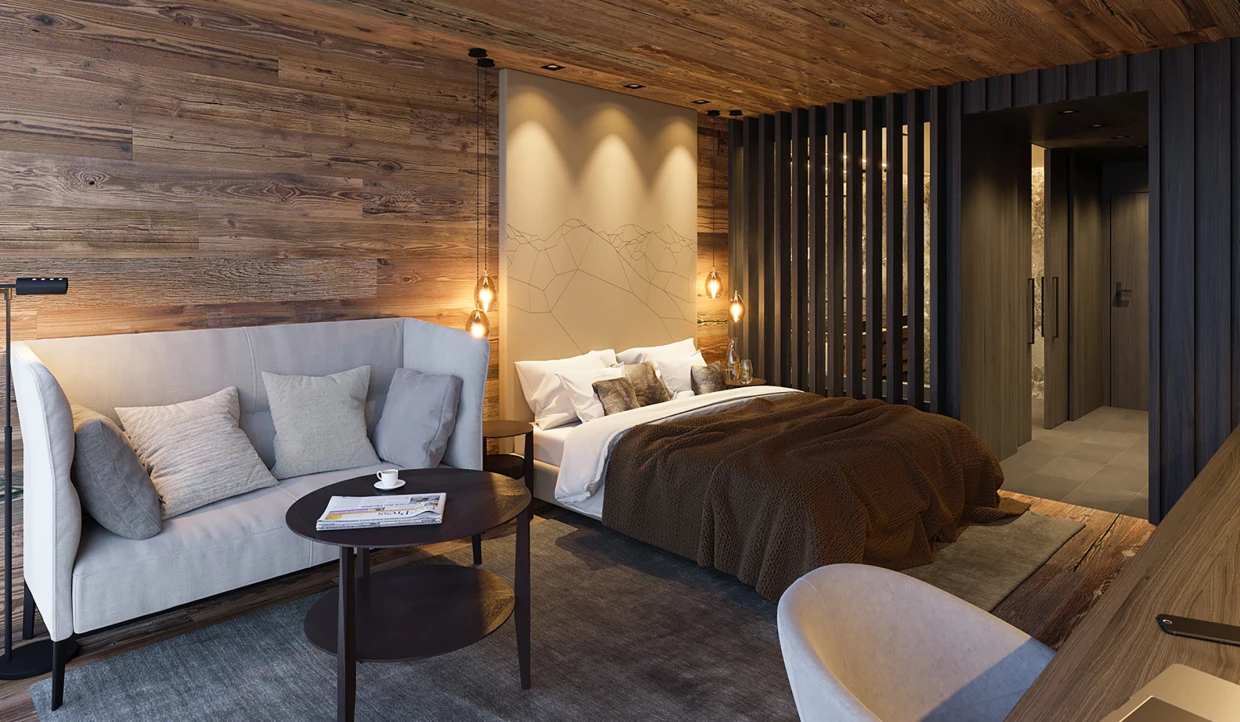 Gemütliches Hotelzimmer mit Bett, Sofa und Holzwänden