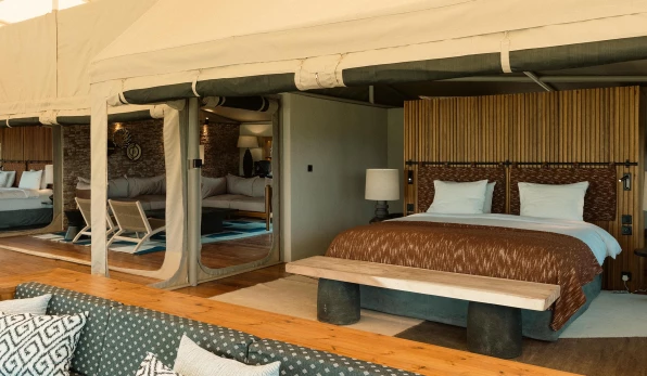 Spacious tent room with comfortable bed and seating area
