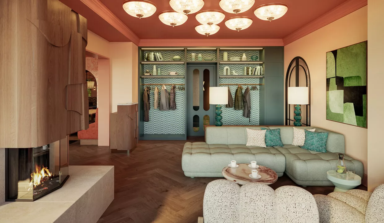 Lobby mit Kamin und beigem Sofa, viele Kissen