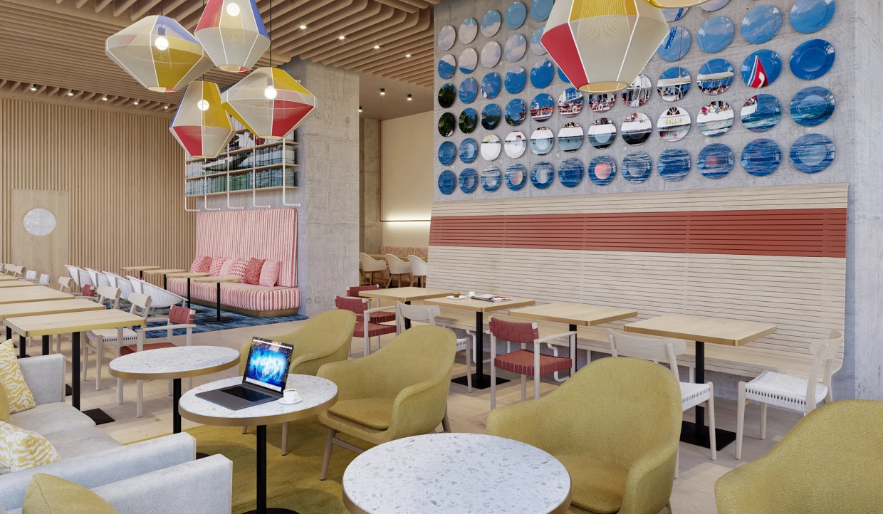 Restaurant area with yellow chairs, tables, and colorful wall decoration