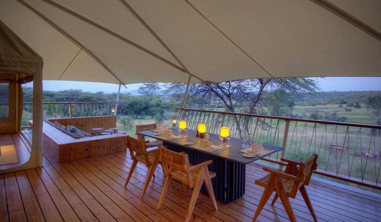 Dining area on veranda with candles and wine glasses