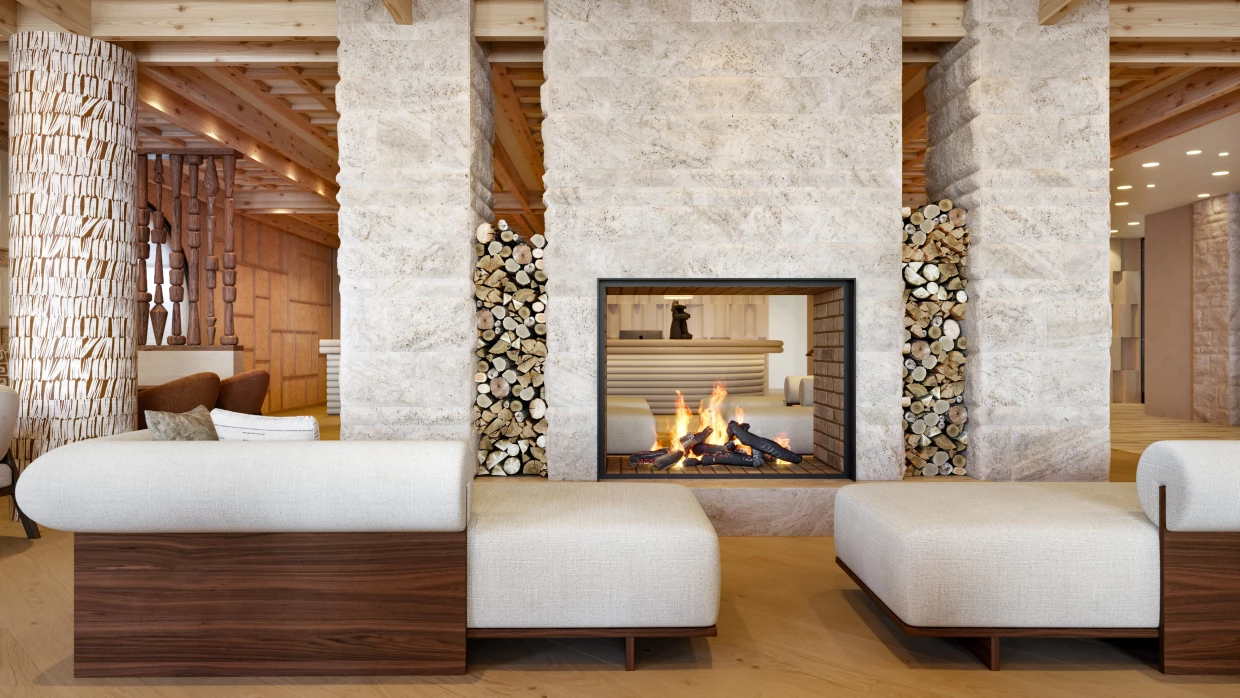 Bright natural stone fireplace in the lobby of a luxury hotel in Graubünden
