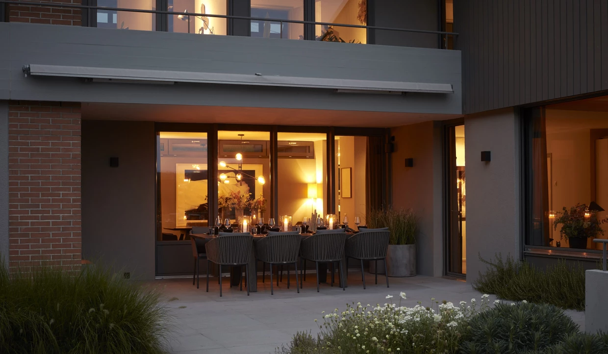 Dusk, exterior view of a house with illuminated dining area