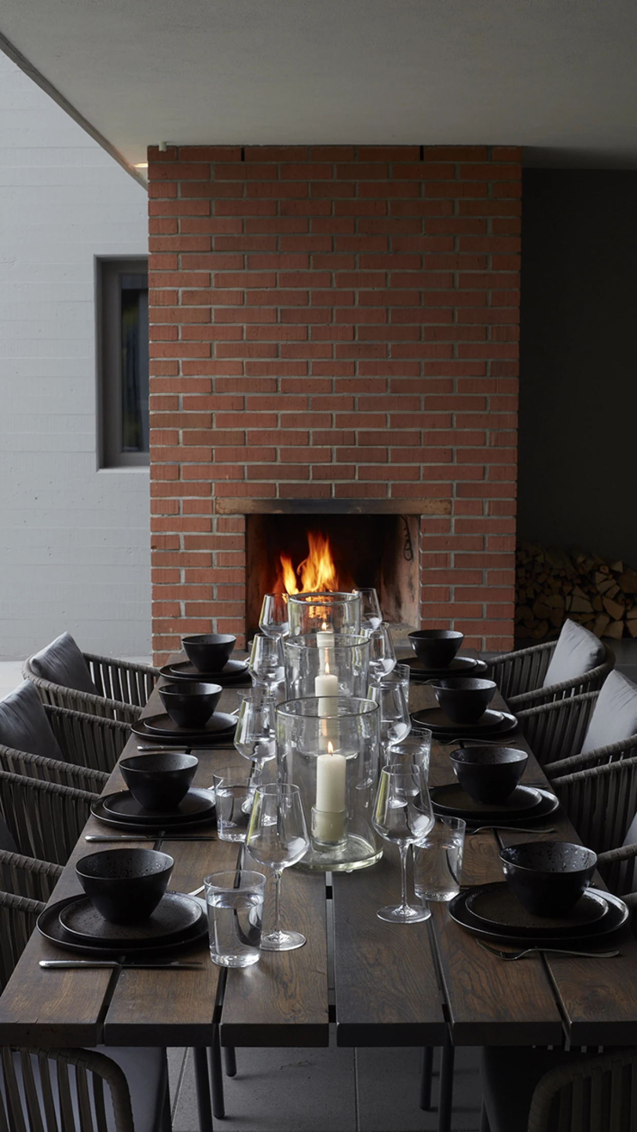 Dining area with fireplace and set table with dishes and candles
