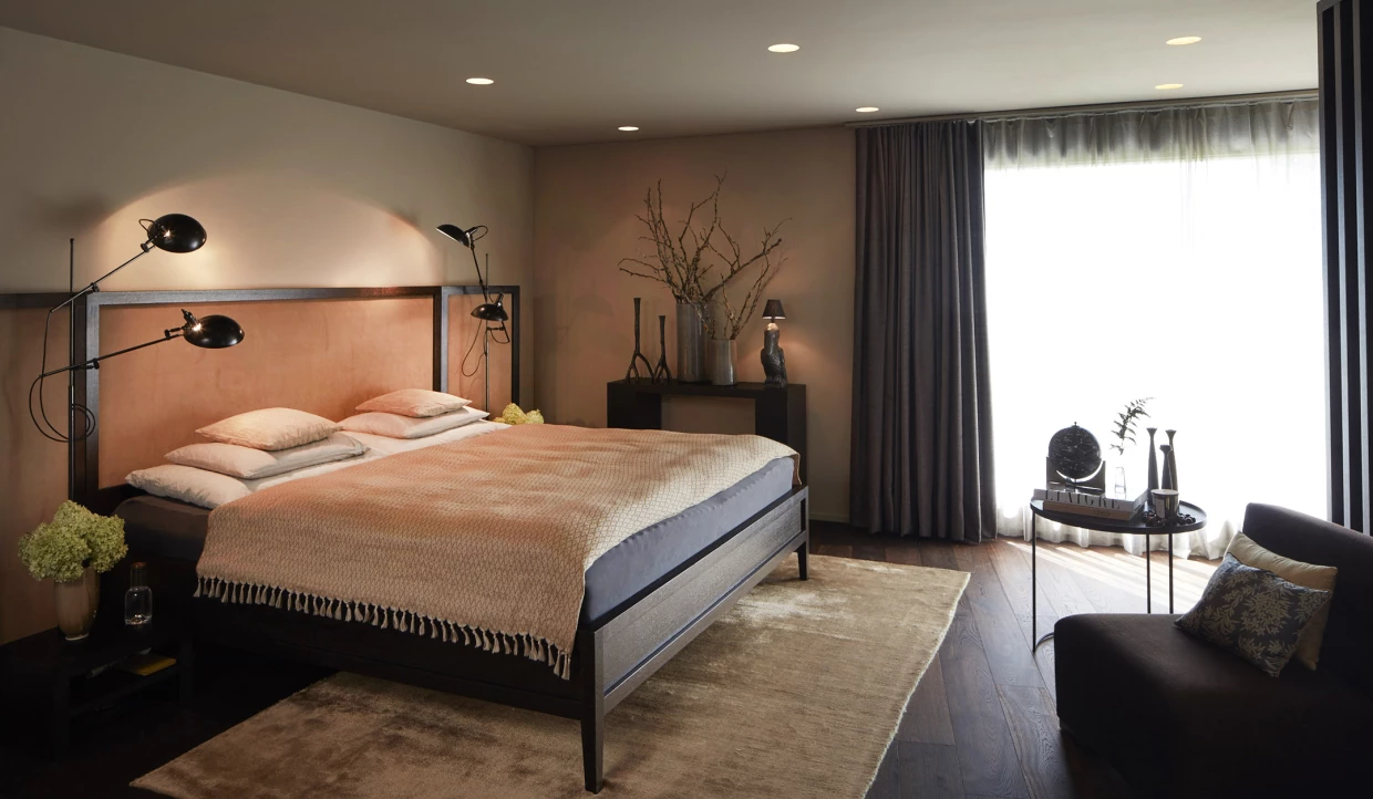 Cozy bedroom with large bed, lamps, and curtains