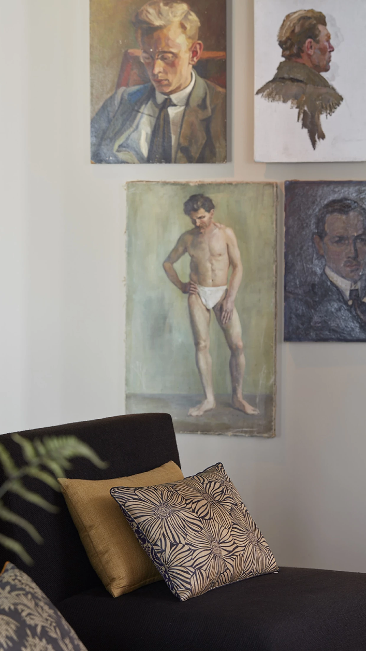 Interior with art paintings on the wall above a modern sofa