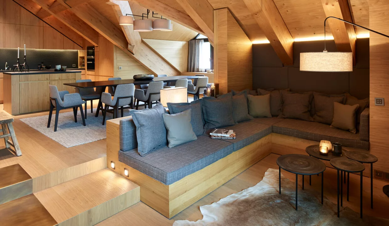 Open living area with sofa, table and kitchen