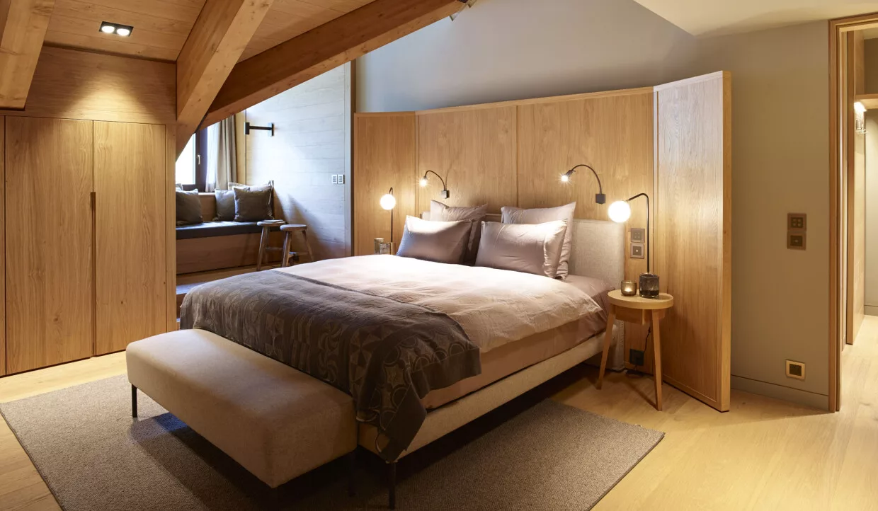 Bedroom with bed, wooden walls and ceilings