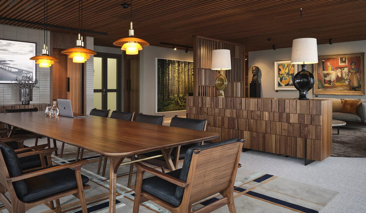 Dining area with wooden table, lamps, and wall art