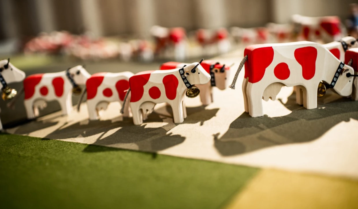 Close-up of small red and white cow figures
