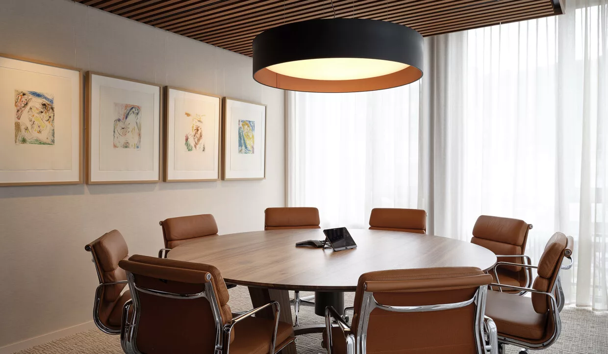 Round table with brown chairs and wall art