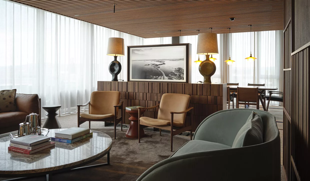 Seating area with armchairs, coffee table, and large lamps