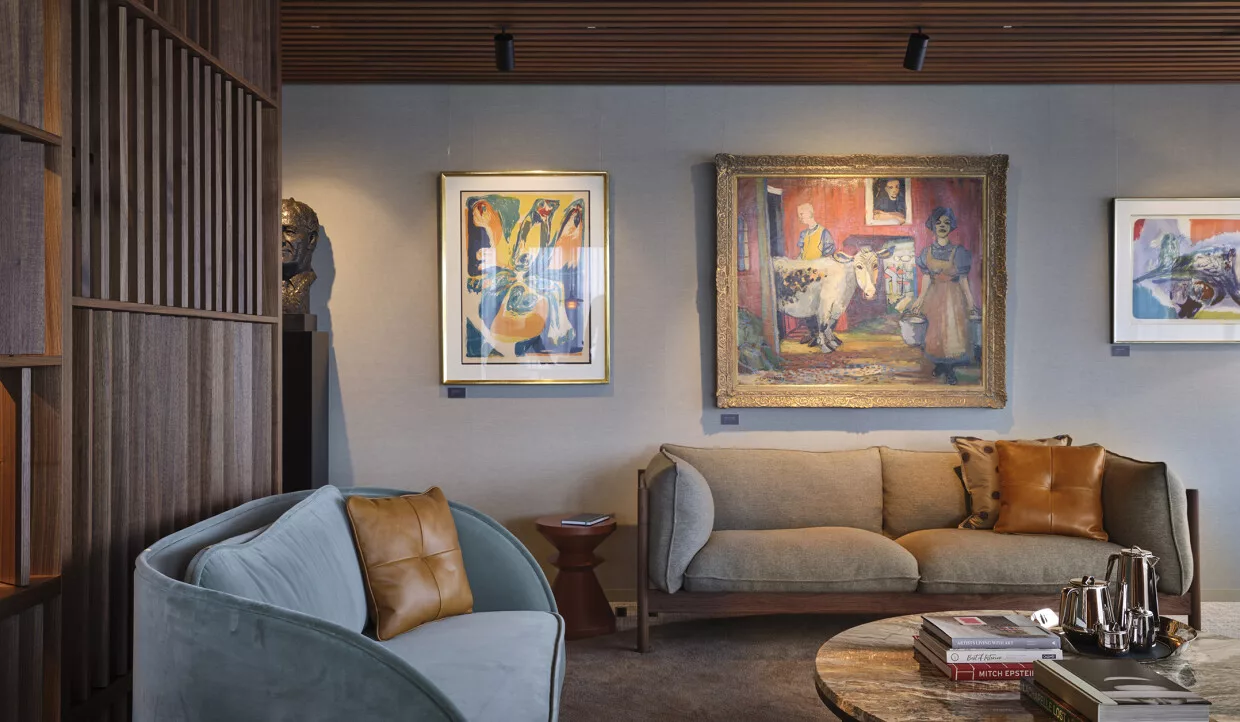 Seating area with armchairs and paintings on the wall