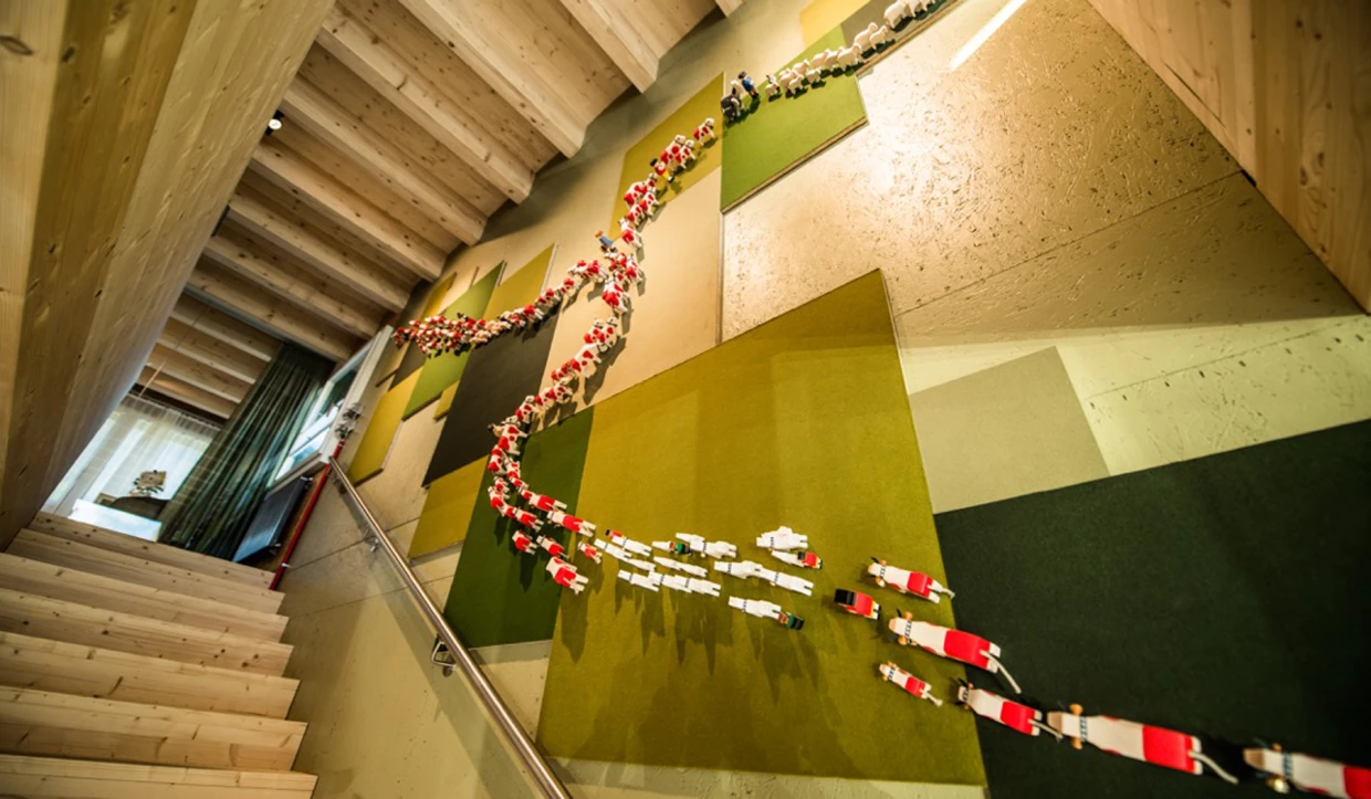 Wall decoration of threaded cow figures next to stairs