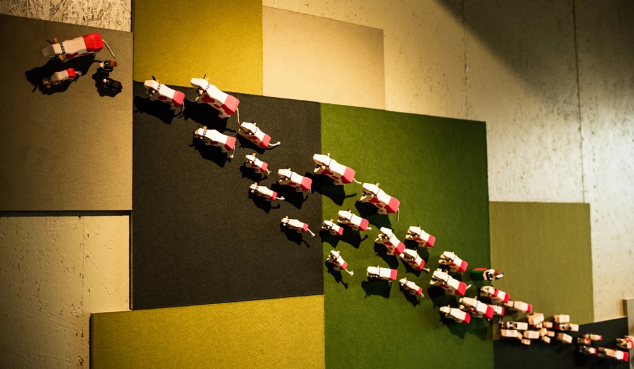 Wall decoration with small red and white cow figures