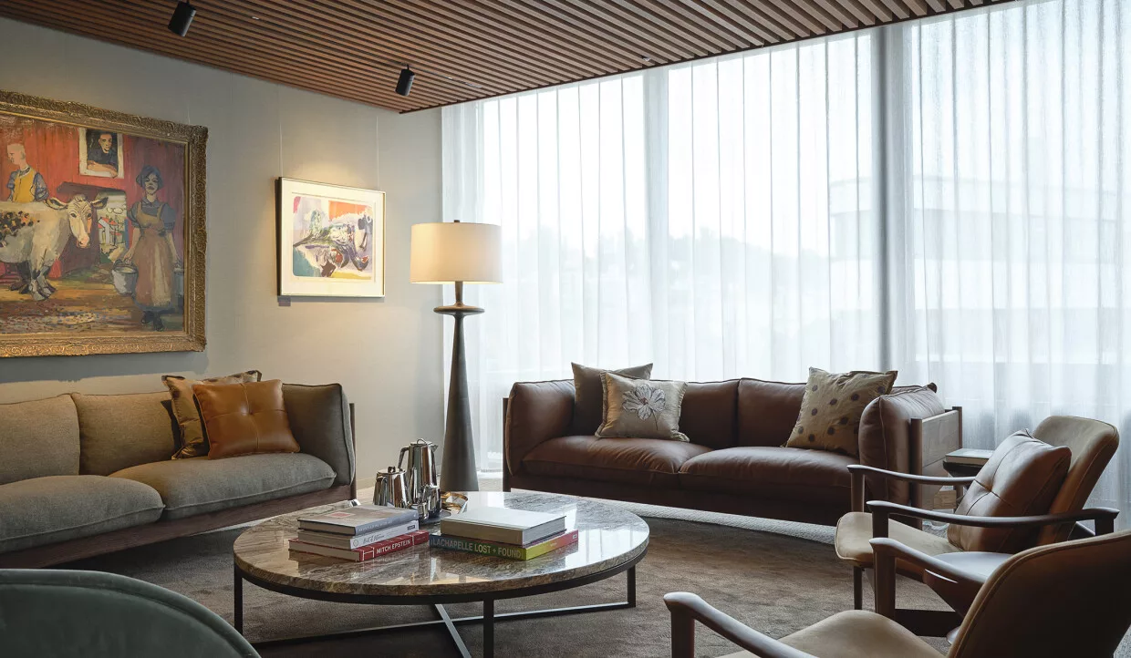 Living area with sofas, paintings, and floor lamp