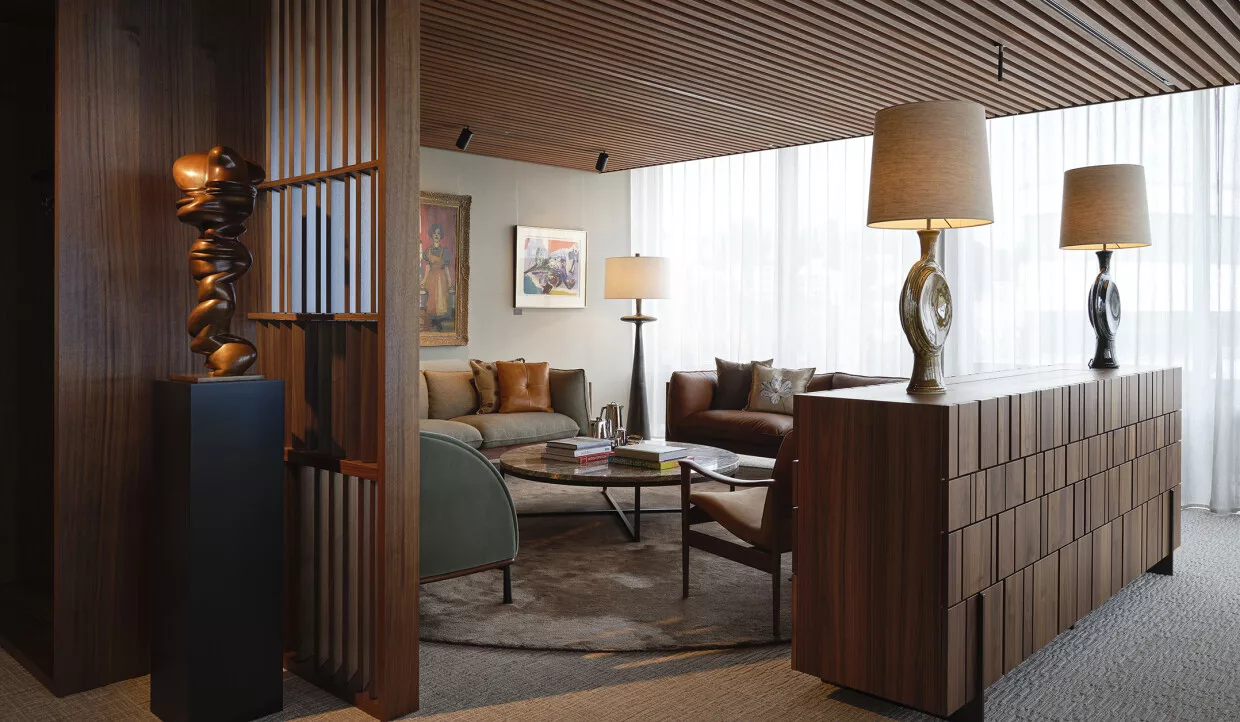 Living room with sofas, coffee table, and sculpture