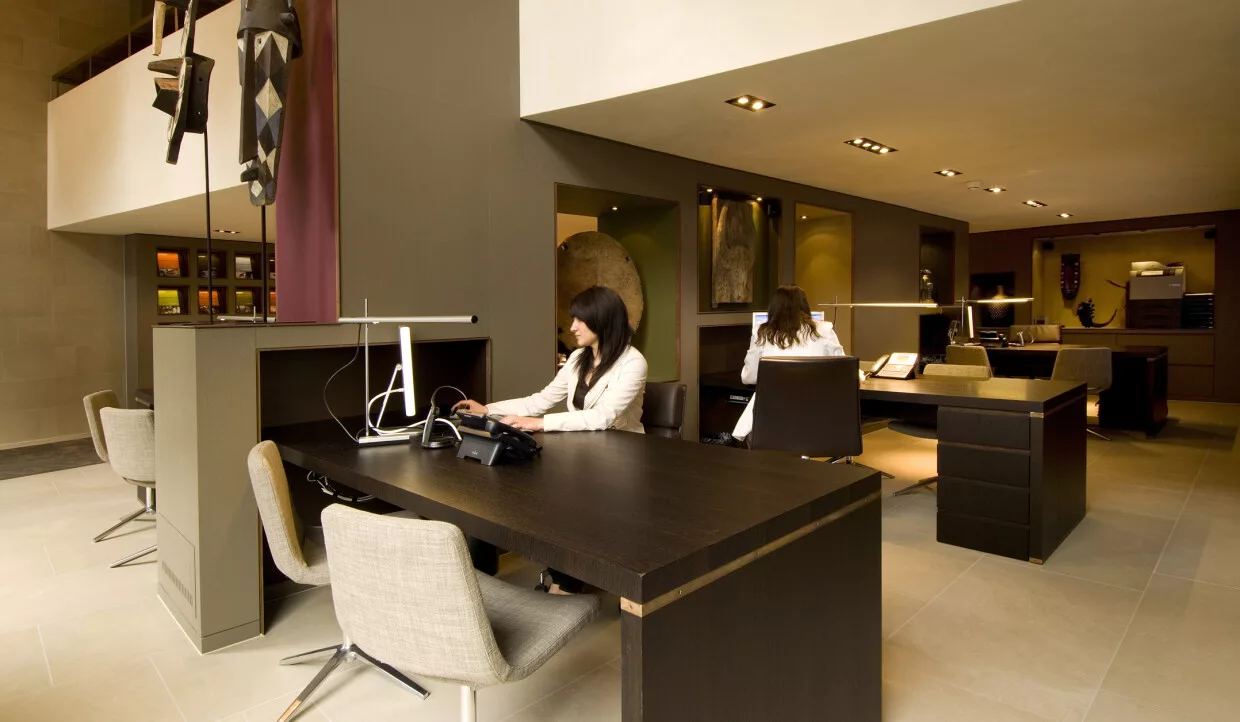 Two people working at dark desks
