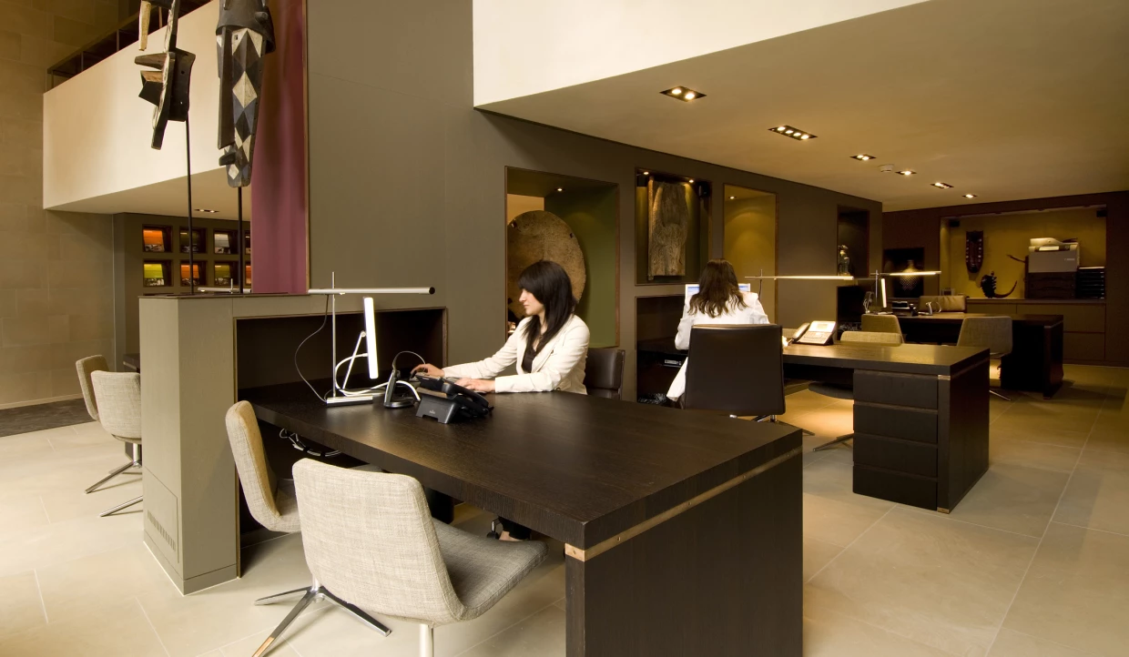 Two people working at dark desks