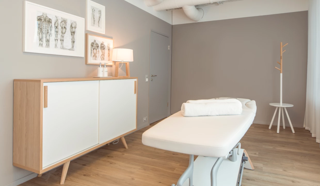 Treatment room with couch and anatomical drawings