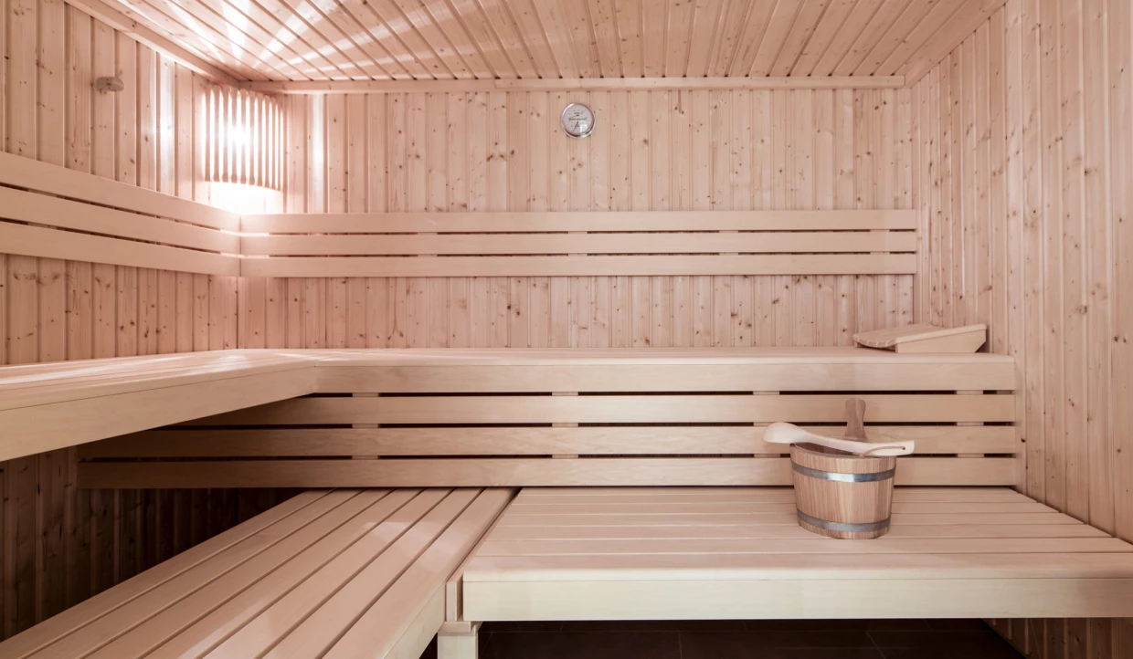 Wooden sauna with bench and bucket