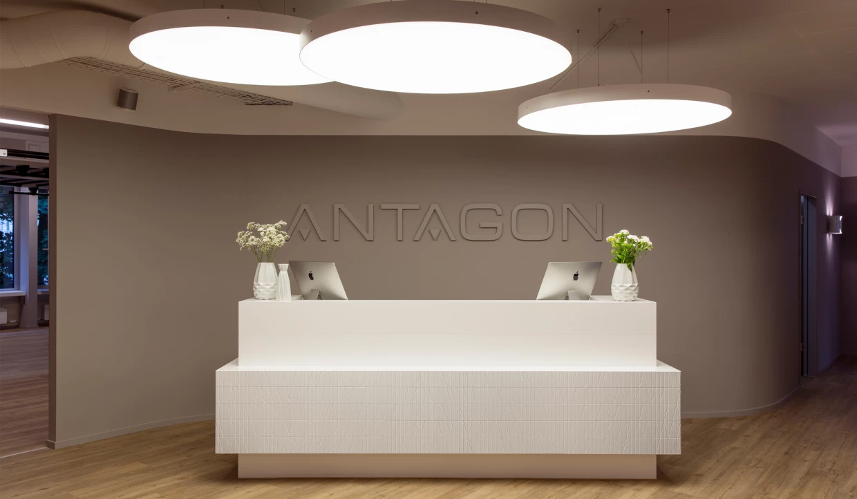 Reception desk with two computers and flower vases
