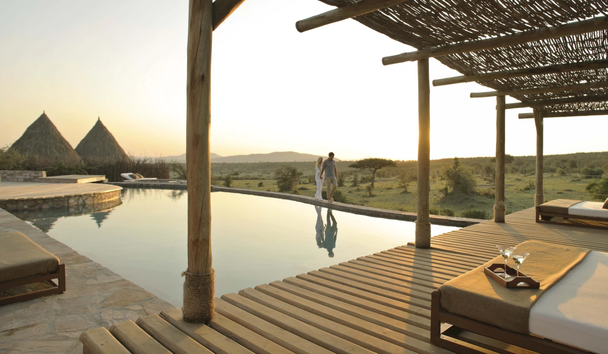 View from the terrace of a luxury safari lodge with sun loungers by the pool