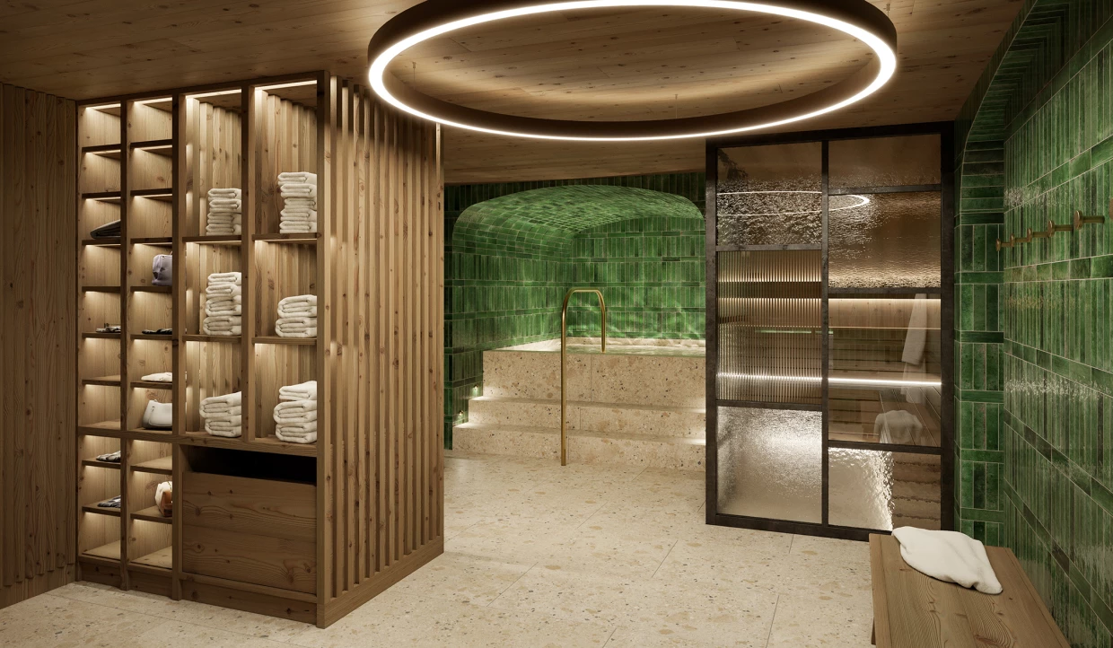 Wellness area of a hotel with wooden shelves and green wall tiles. View of a sauna and a whirlpool.